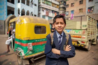 Portrait of a schoolboy in uniform on the street in Kolkata, India.