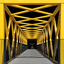 Photo art: Image of a bridge with a girl in yellow symbolizing repression.