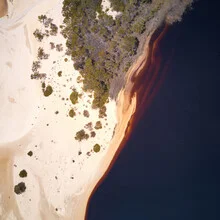 Sand dune in Australia, gentle waves of sand beneath a clear sky.