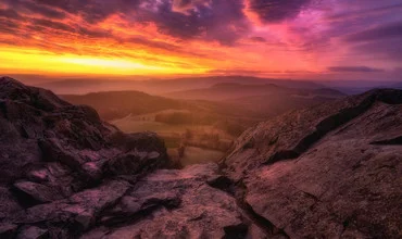 Colorful view of clouds over mountains during sunrise.