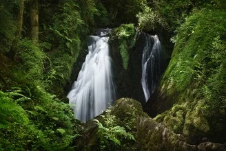 Photo art by Alex Wesche: hidden waterfall in lush Eifel landscape