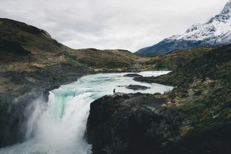 Waterfall scene in Patagonia, featuring rugged rocks and flowing water