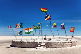 Photo art by Christine Wawra: colorful flags above a salty landscape in Bolivia.