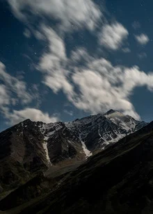Photo art by Michael Wagener: night view of snow-covered Himalaya mountains under stars.