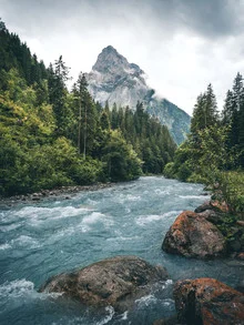 Photo art by Niels Oberson: serene landscape featuring mountains and a clear stream