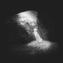 Black and white photo art: beams of light through darkness symbolizing hope.
