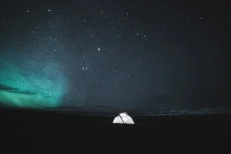 Photo art by Christoph Johann: tent in the mountains under the Northern Lights