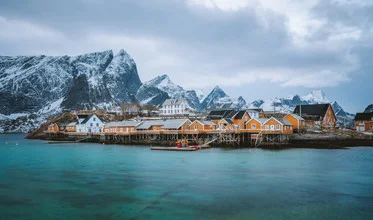Charming village of Sakrisøy in Norway with colorful huts and calm waters