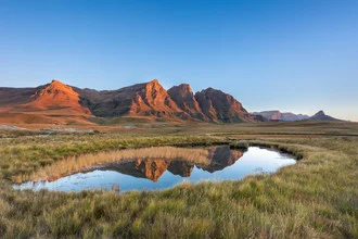 Photo art by Dirk Steuerwald: serene lake with orange sunrise in Lesotho