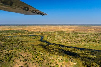Aerial view of Namibia showcasing a green river and desert landscape