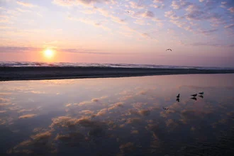 Photo art by Oona Kallanmaa: serene sunrise over the ocean with soft clouds