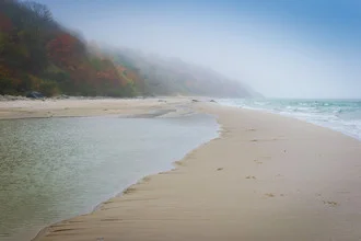 Gentle coastal landscape in fog, the calm Baltic Sea embraces the northern beach.