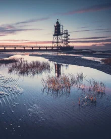 Photo art of a lighthouse at blue hour, reflected in calm water