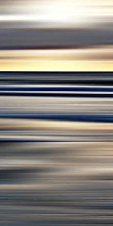 Calm water surface with gentle waves under golden sunlight
