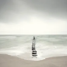 Photo art featuring a calm breakwater on a coast at sunset