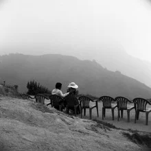 Couple happily enjoying the tea plantations of Munnar with mountain views