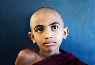Photo art by Victoria Knobloch: a little monk smiles in Sri Lanka.