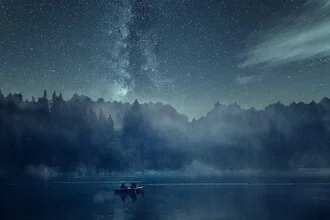 Night scene on the lake with sparkling stars and the Milky Way in the background.