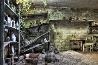 Abandoned workshop in Belgium, featuring an old chair and nostalgic atmosphere.