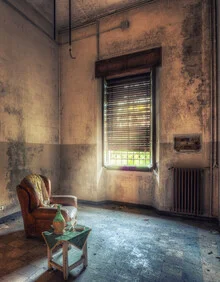 A drink on a table inside an abandoned church, gentle light streaming in.