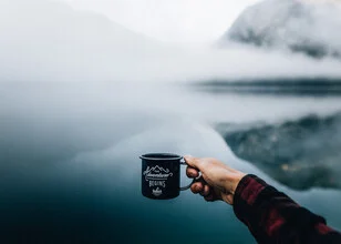 Photo art by Stefan Sträter: coffee mug set against the Austrian mountains.