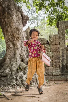 Happy girl in front of Angkor Wat in Cambodia with a bright smile