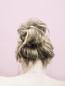 Portrait of a blonde woman with a ponytail, gentle expression on her back.