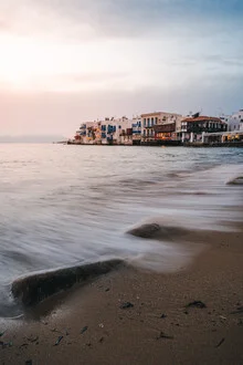 Charming scene in Little Venice, Mykonos with colorful houses and calm water.