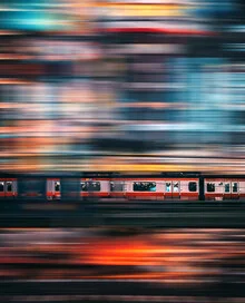 Night photo of a train in Tokyo, illuminated cityscape, calm atmosphere.