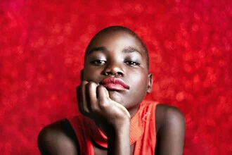 Photo of a Ugandan girl with a pensive expression in stylish clothing