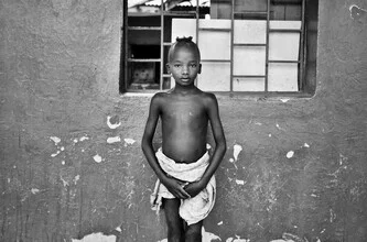 Photo art of an African boy in Dimeka, smiling gently at the camera.