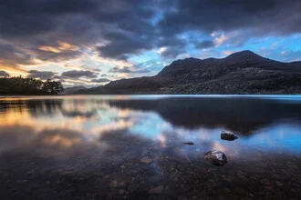 Photographic depiction of Loch Maree sunset in Scotland with colorful clouds.