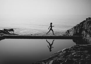 Black and white photo art by Julian Wedel: woman walking gracefully by the pool