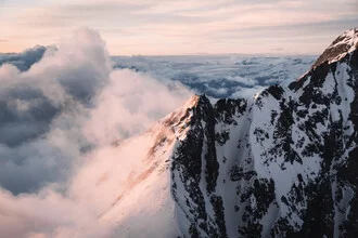 Photo art of snow-capped mountains in evening light, soft colors and a calm mood.
