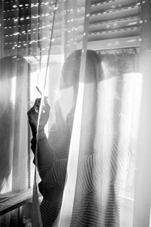 Girl smoking by the window, light and shadows dance in the curtain.