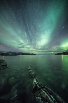 Photo art by Sebastian Worm: Northern lights over a coastal landscape in Norway.