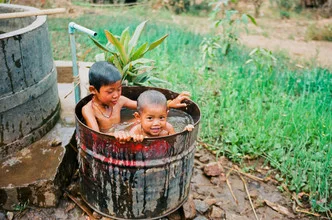 Photo art by Jim Delcid: Children at Inle Lake playing with water and buckets.