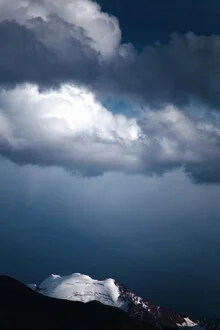 Photo art by Victoria Knobloch: Snowy mountains beneath a dramatic sky
