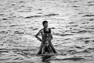 Photo art by Victoria Knobloch: a riding boy in a mountain lake of Kyrgyzstan