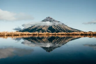 Photo by Tobias Winkelmann: Mount Taranaki reflects in serene water.