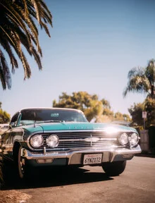 Photo art by Sebastian Trägner: sun, beach, and a red car beneath palm trees