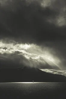 Photo art by Sebastian Worm: sailing boat on calm water under dramatic clouds