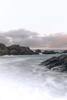 Rocks along the Norwegian coast with gentle Atlantic waves in the background.