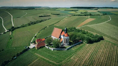 Abandoned church in a wide field, creating a peaceful and calm atmosphere.