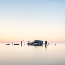 Photo art by Ronny Behnert: serene fishing hut by the water in Venice at sunset.