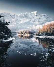 Fotografie von Eibsee mit spiegelndem Wasser und schneebedeckten Bergen.