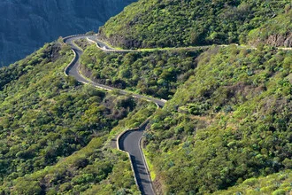 Peaceful landscape with green mountains and a winding road in Teno, Tenerife.