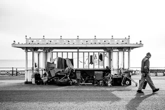 Photography of a beach walk in Brighton featuring a man in a hat.