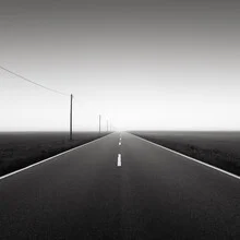 Black and white photo art: foggy road in a minimalist perspective