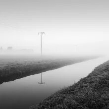 Photo art by Thomas Wegner: power poles in fog over a calm river